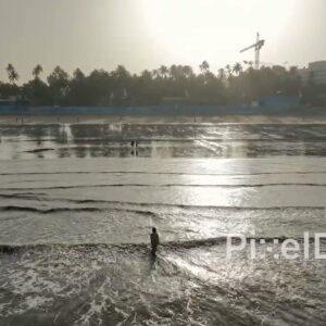 PD0507 - Contemplative Moment: Lone Figure in the Ocean at Sunrise