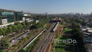 PD0549 - Commuter Train Passing a Modern Business Park in Navi Mumbai