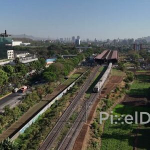 PD0549 - Commuter Train Passing a Modern Business Park in Navi Mumbai