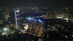 PD0638 - Luxury Urban Living: An Aerial View of a Modern Illuminated Skyscraper