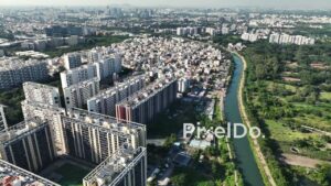 PD0627 - Urban Landscape: A Goods Train Travels Through a Green Corridor in Pune