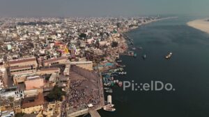 PD0655 - High Angle Drone Shot of Pilgrims at a Bustling Ghat on the Ganges River