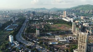 PD0710 - Sweeping Drone Shot of the Developing Navi Mumbai Cityscape with a Mountain Backdrop