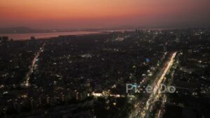 PD0700 - Sweeping Drone Shot of a Metropolis with a Red Sunset Afterglow