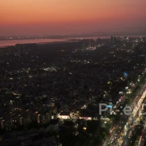 PD0700 - Sweeping Drone Shot of a Metropolis with a Red Sunset Afterglow