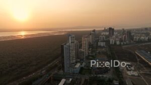 PD0697 - Golden Hour Aerial View of Palm Beach Road and a Coastal Cityscape at Sunset