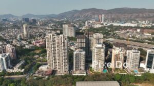 PD0681 - Sweeping Aerial of a Modern Residential Area with a Mountain Backdrop