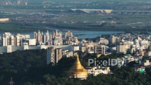 PD0729 - Aerial View Juxtaposing a Golden Pagoda and the New Navi Mumbai Airport Construction