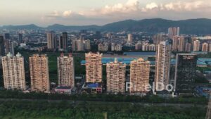 PD0728 - Sweeping Drone Shot of Palm Beach Road's Skyline with a Mountain Backdrop
