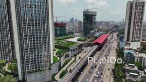 PD0749 - Aerial View of a Metro Train and Highway Traffic in a Modern Metropolis