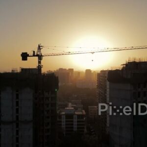 PD0132 - Aerial View of a Construction Site Crane Silhouetted Against a Hazy Sunset