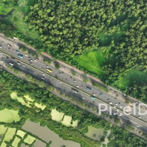 PD0122 - Top-Down Aerial View of a Busy Highway Through a Green Forest in Mumbai, India