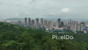 PD0120 - Aerial View of Mumbai's Urban Skyline Next to a Lush Green Forest