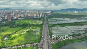 PD0111 - Aerial View of the Eastern Express Highway and Lush Green Salt Pans During Monsoon in Mumbai