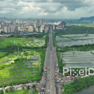 PD0111 - Aerial View of the Eastern Express Highway and Lush Green Salt Pans During Monsoon in Mumbai