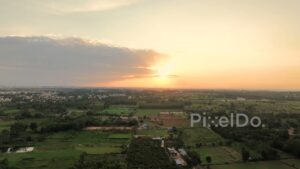PD0188 - Aerial View of a Golden Sunset Over a Lush Rural Landscape in India