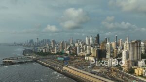 PD0063 - Aerial View of Mumbai's Skyline and Coastal Road Construction Under a Monsoon Sky