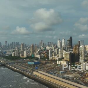PD0063 - Aerial View of Mumbai's Skyline and Coastal Road Construction Under a Monsoon Sky