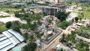 PD0176 - Aerial View of a Traditional Temple Amidst Modern Urban Development
