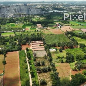 PD0174 - Aerial View of a Large Stone Quarry Bordering Green Agricultural Land in India