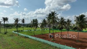 PD0164 - Aerial Shot of a Tractor Plowing a Field with Urban Skyline in the Background