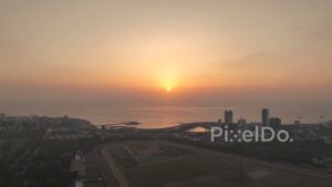 PD0254 - Aerial View of a Hazy Golden Sunset Over the Mumbai Cityscape and Sea
