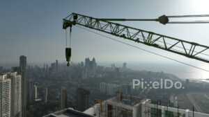 PD0245 - Aerial View of a Construction Crane Atop a Skyscraper Overlooking the Mumbai Skyline
