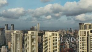 PD0369 - Majestic Aerial Rise Past Mumbai Skyscrapers Revealing the Cityscape and Sea