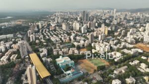 PD0353 - Aerial Pan of a Dense Mumbai Suburb with Metro and Railway Infrastructure
