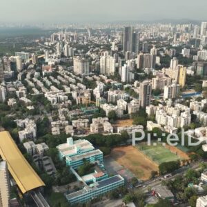 PD0353 - Aerial Pan of a Dense Mumbai Suburb with Metro and Railway Infrastructure
