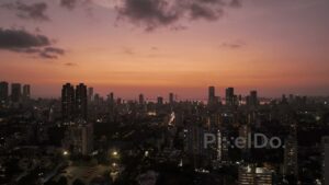 PD0388 - Twilight Glow Over Mumbai Skyline with Illuminated City Lights, Aerial View