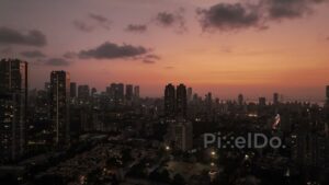 PD0387 - Twilight Glow Over Mumbai Skyline with Illuminated City Lights, Aerial View