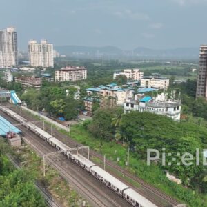 PD0051 - Aerial View of a Mumbai Local Train, the City's Lifeline, Passing Through a Suburb