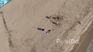 PD0498 - Top-Down Aerial of Friends Playing on a Sandy Beach