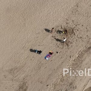 PD0498 - Top-Down Aerial of Friends Playing on a Sandy Beach