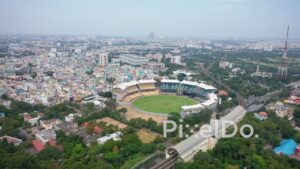 PD0837 - Aerial Reveal of Chennai's Coastal Cityscape and Cricket Stadium