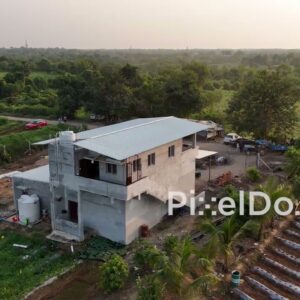 PD0821 - Aerial Orbit of a Farmhouse Under Construction Amidst Farmlands