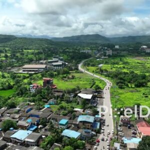 PD0759 - Aerial Drone Flight Over a Rural Village in a Lush Green Valley