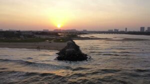 PD0903 - Stunning Aerial View of a Jetty and Beach at Sunset