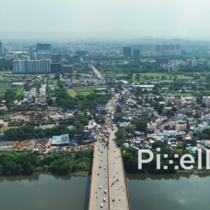 PD0752 - Aerial Drone Shot Flying Over a Busy Urban Bridge in Pune