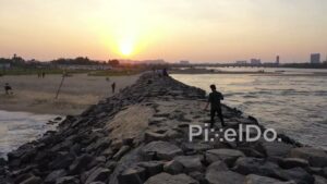 PD0901 - Aerial Flight Along a Coastal Jetty at Sunset