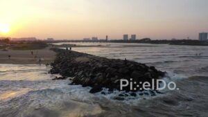 PD0900 - Cinematic Aerial Orbit of a Man on a Jetty at Sunset