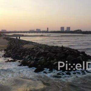 PD0900 - Cinematic Aerial Orbit of a Man on a Jetty at Sunset