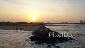 PD0899 - Aerial Orbit of a Man on a Jetty During a Golden Sunset