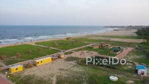 PD0897 - Aerial Orbit of a Scenic Beach Park at Sunset