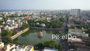 PD0886 - Aerial Orbit of a Sacred Temple Tank in a Coastal City