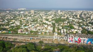 PD0880 - Aerial View of Chennai's Coastal Cityscape with Urban Art and Train