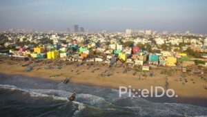 PD0932 - Drone Glides Along a Colorful Fishing Village by the Sea