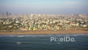 PD0930 - Aerial Panorama of Chennai's Coastline: Fishing Village and Urban Skyline