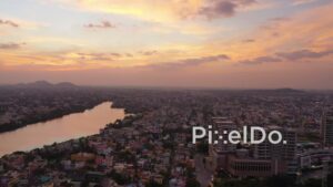 PD0927 - Aerial Pan of a Riverside City at Sunset